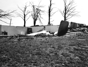 This home was swept away and the concrete walls of the the partially above ground basement severely buckled. Credit: Don Macy