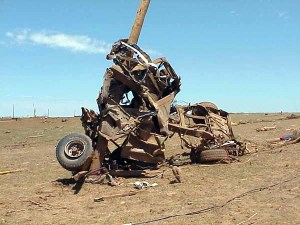This picture of a pickup truck stripped to the frame rails and wrapped around a telephone pole became arguably the most iconic image of the outbreak.