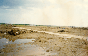 There were once homes here. All that's left is the access road. The homes vanished and the driveways were torn up or buried in mud. Credit: Junga (Flikr)