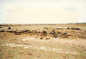 This is the site of a home that was completely wiped out. Even the foundation was torn up and carried away. The people who lived here died in the tornado. You can see flowers left on cinder blocks in the foreground. Note the tires and axle of a car left on the site. Credit: Junga (Flickr)