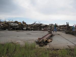 This industrial warehouse was completely leveled and partially swept away. Note the crumpled steel beams in the background. Credit: NOAA